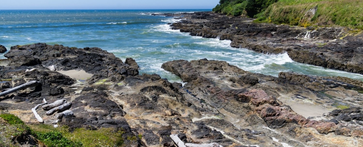 Oregon coast inlet and rocky shore.