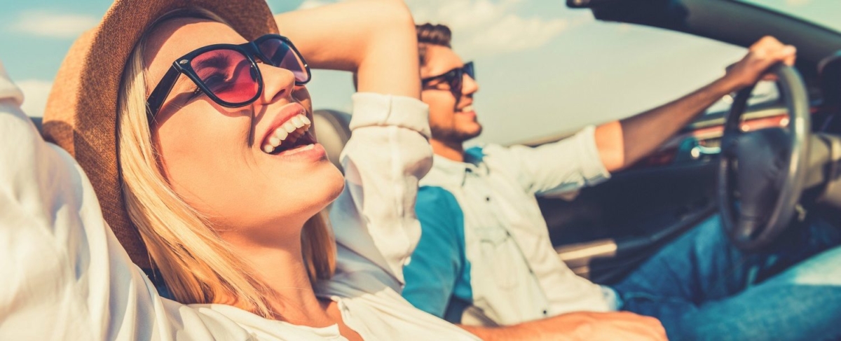 Couple driving and laughing.