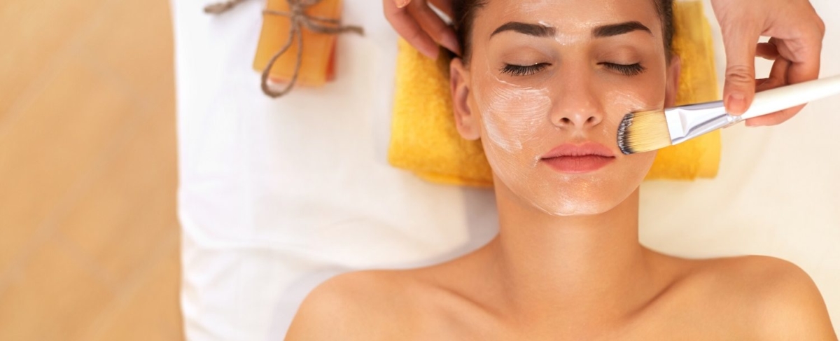 Woman getting a facial scrub.