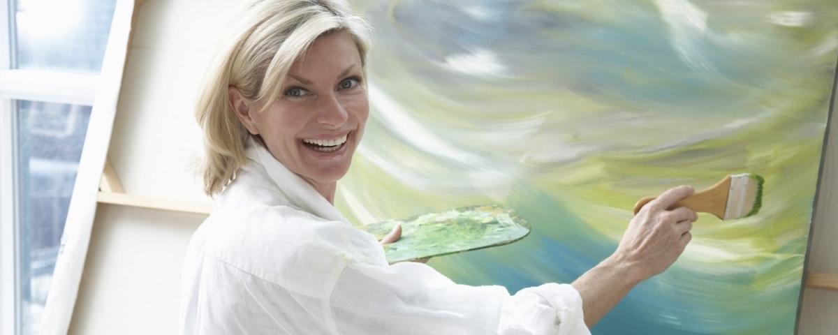 Happy woman painting.