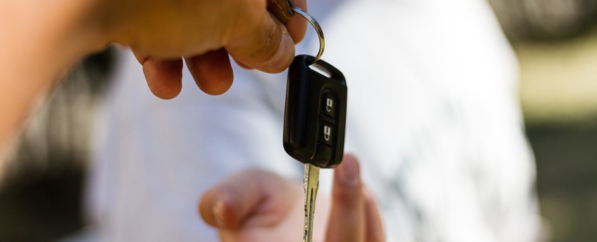 Close up of car key being handed off.