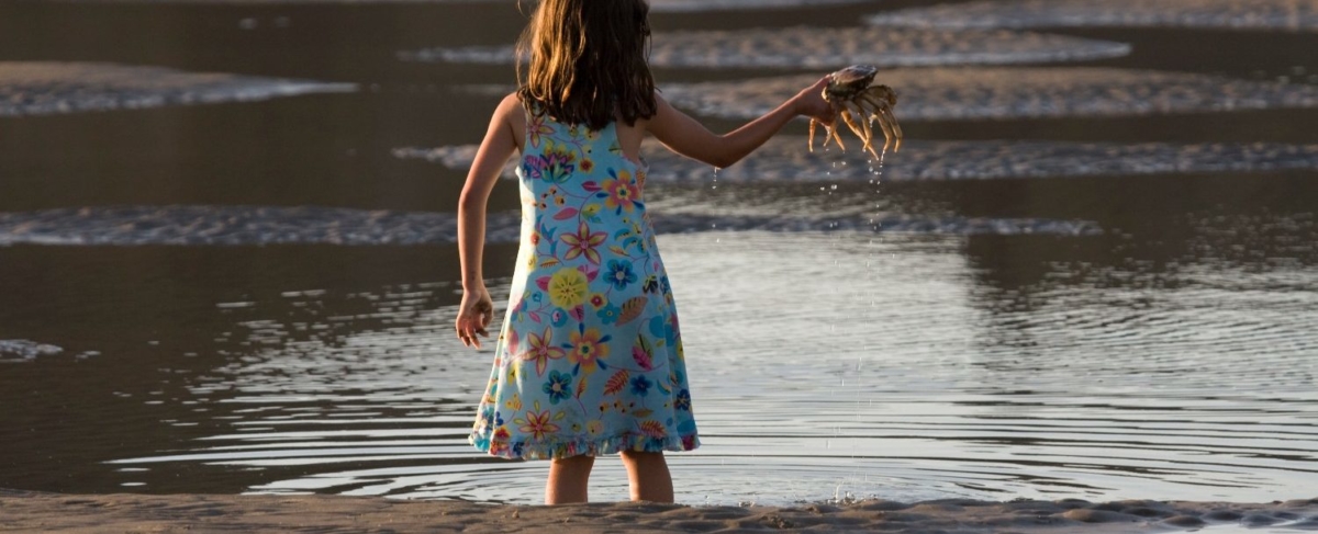 Young girl holding a crab.