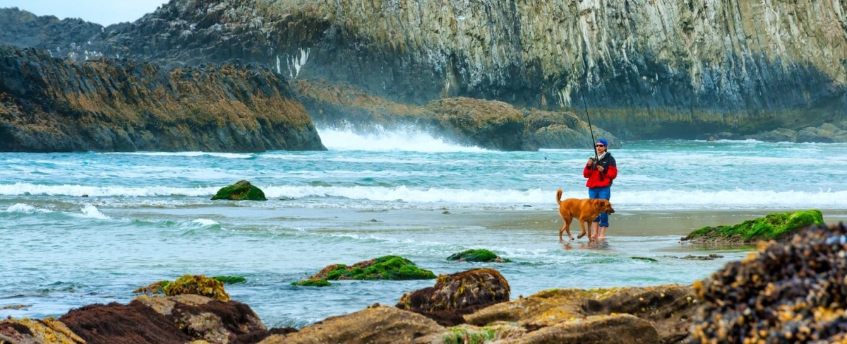 Coastal Fisher with a dog.