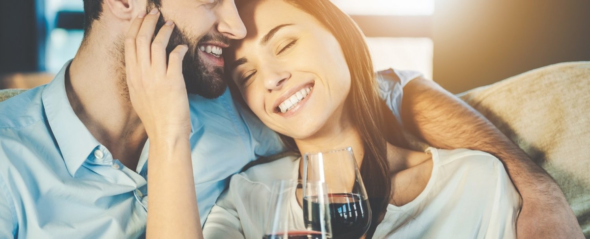 Couple on a couch with wine.