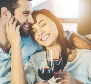 Couple on a couch with wine.