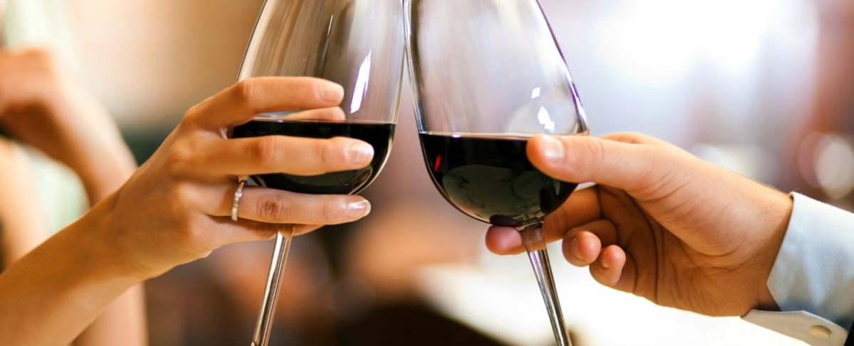 Close up of couples clinking wine glasses.