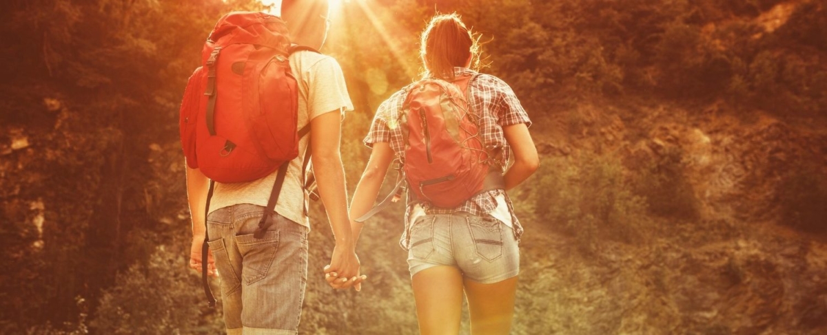 Hiking couple holding hands.