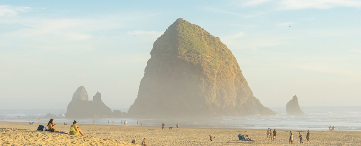 Beachgoers on the coast near Haystack Rock.