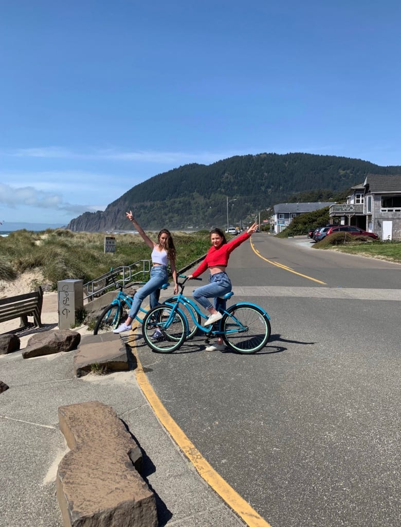 Girls on bikes by the beach