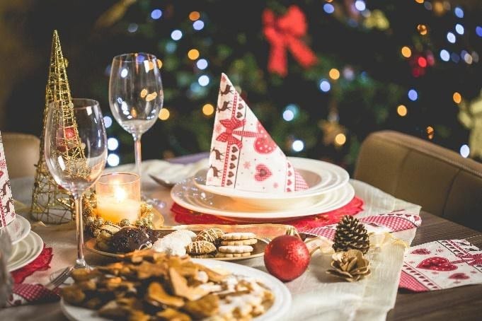 Holiday dinner table with cookies and ornaments.